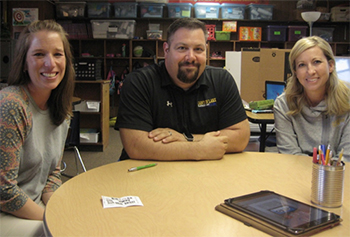 Photo of  Canyon Lake Elementary 3rd grade teacher Carrie Baker, Principal David Swank, dean of students and instructional support teacher Cari Clark sitting at table.