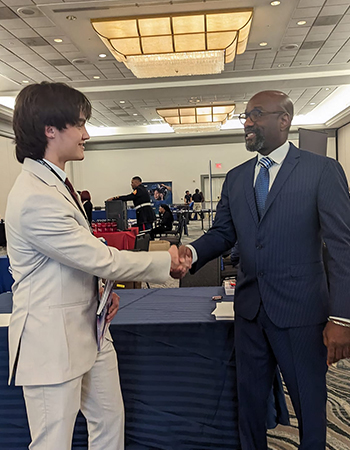 images of JAG-SD Student shaking hands with business leader.