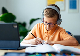 stock photo of students at laptop with headphones