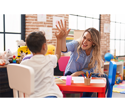 photo of counselor giving student high-five