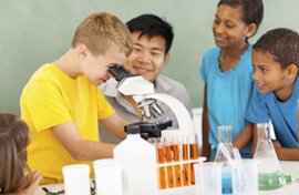 Stock photo of students looking into microscope