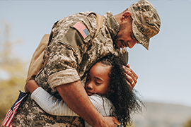 Image of US soldier hugging child.